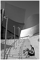 Women sunning on the steps of the entrance of the Walt Disney Concert Hall. Los Angeles, California, USA ( black and white)