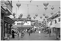 Lanterns and pedestrian street in rainy weather,  Chinatown. Los Angeles, California, USA (black and white)