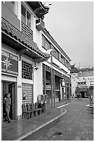 Man at doorway and plaza, Chinatown. Los Angeles, California, USA (black and white)