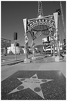 Star from the Hollywood walk of fame and gazebo with statues of actresses. Hollywood, Los Angeles, California, USA (black and white)