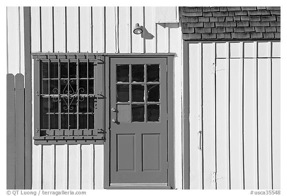 Facade of house with blue doors and windows. Marina Del Rey, Los Angeles, California, USA (black and white)