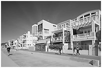 People jogging and strolling on beach promenade. Santa Monica, Los Angeles, California, USA (black and white)