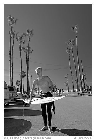 Surfer and palm trees. Venice, Los Angeles, California, USA