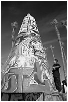 Man creating  graffiti art. Venice, Los Angeles, California, USA ( black and white)