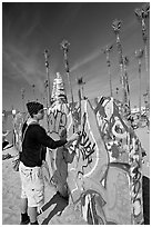 Young man making graffiti on a wall. Venice, Los Angeles, California, USA ( black and white)