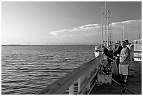 Fishing in the Port of Redwood, late afternoon. Redwood City,  California, USA (black and white)