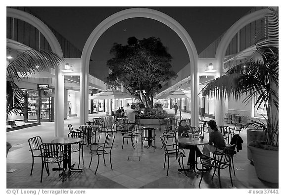 Sitting at outdoor table at night, Stanford Shopping Center. Stanford University, California, USA
