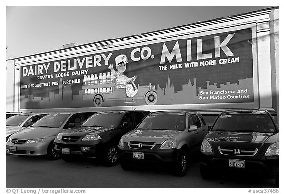Historic advertising mural, in a car dealership lot. Burlingame,  California, USA (black and white)