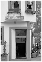 Entrance of historic San Benito House, with couple looking. Half Moon Bay, California, USA ( black and white)