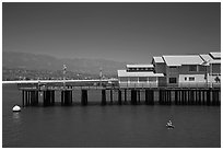 Man on buoy and pier. Santa Barbara, California, USA (black and white)