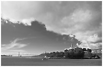 Golden Gate Bridge and Alcatraz under large cloud. San Francisco, California, USA ( black and white)