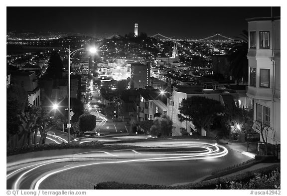 Sharp switchbacks on Russian Hill with Telegraph Hill in the background, night. San Francisco, California, USA (black and white)
