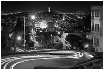 Sharp switchbacks on Russian Hill with Telegraph Hill in the background, night. San Francisco, California, USA ( black and white)
