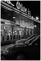 Neon lights of Mels drive-in reflected on parked cars. San Francisco, California, USA ( black and white)