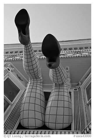 Legs with fishnet stockings hanging from a window, Haight-Ashbury District. San Francisco, California, USA (black and white)