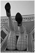 Legs with fishnet stockings hanging from a window, Haight-Ashbury District. San Francisco, California, USA ( black and white)