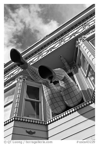 Giant legs with stockings hanging from a second floor, Haight-Ashbury District. San Francisco, California, USA (black and white)
