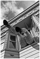 Giant legs with stockings hanging from a second floor, Haight-Ashbury District. San Francisco, California, USA (black and white)