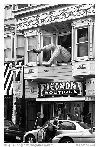 Woman exiting car below women legs with stockings. San Francisco, California, USA (black and white)