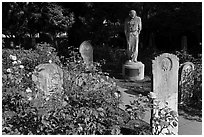 Gravestones and statue, Mission Dolores. San Francisco, California, USA ( black and white)