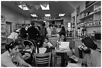 Indian family inside popular pizza restaurant, Haight-Ashbury district. San Francisco, California, USA ( black and white)