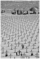 War memorial and families at edge of water on beach. Santa Monica, Los Angeles, California, USA ( black and white)