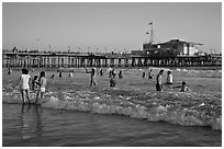 Beach shore and Santa Monica Pier, late afternoon. Santa Monica, Los Angeles, California, USA (black and white)