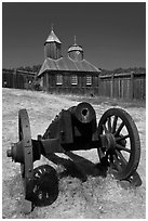 Cannon and Russian chapel inside Fort Ross. Sonoma Coast, California, USA (black and white)