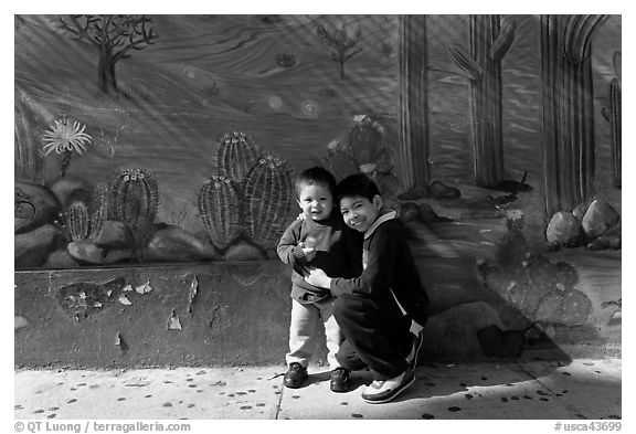 Boys and mural, Mission District. San Francisco, California, USA