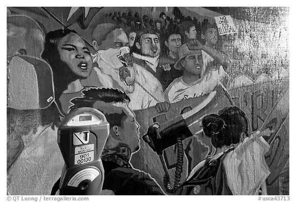 Parking meter and politically charged mural, Mission District. San Francisco, California, USA (black and white)