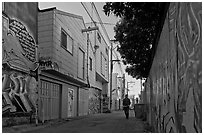 Man walking in alley, Mission District. San Francisco, California, USA ( black and white)