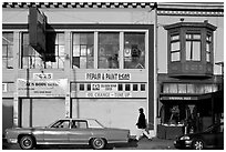 Old car and sidewalk, Mission Street, Mission District. San Francisco, California, USA ( black and white)