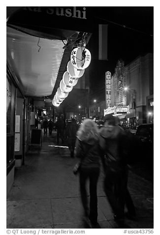 Couple on Castro street at night. San Francisco, California, USA (black and white)