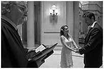 Officiant and couple getting married, City Hall. San Francisco, California, USA (black and white)