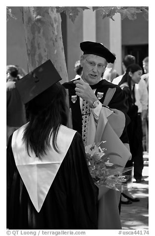 Faculty in academic dress talks with student. Stanford University, California, USA (black and white)