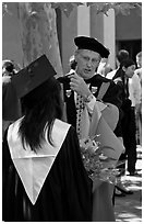 Faculty in academic dress talks with student. Stanford University, California, USA ( black and white)
