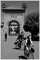 Students riding bicycles through Main Quad. Stanford University, California, USA (black and white)