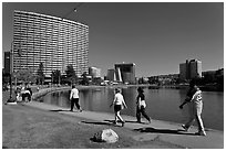 People strolling around 3.5 mile path around Lake Merritt. Oakland, California, USA ( black and white)