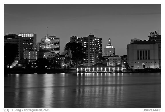 Oakland skyline reflected in Lake Merritt at night. Oakland, California, USA