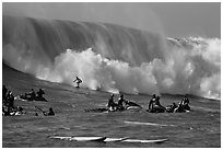 Waverunners and surfer in big wave. Half Moon Bay, California, USA (black and white)