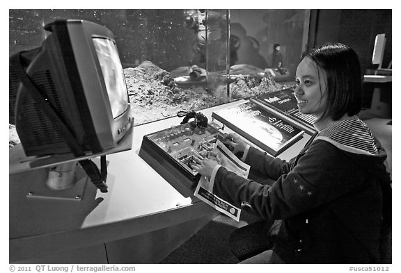 Visitor controls robot, Tech Museum. San Jose, California, USA
