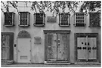 Wall with weathered doors and windows. Santana Row, San Jose, California, USA ( black and white)