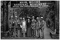 Rangers posing with Theodore Roosevelt under entrance gate. Muir Woods National Monument, California, USA ( black and white)