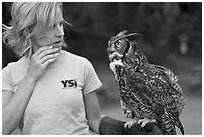 Owl perched on woman's arm, Alum Rock Park. San Jose, California, USA (black and white)