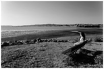 Woman sitting on bench, Carquinez Strait Regional Shoreline. Martinez, California, USA ( black and white)