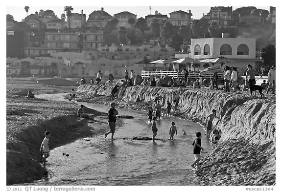 Children playing in tidal stream. Capitola, California, USA (black and white)