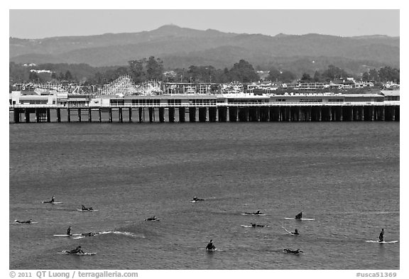 Surfers and municipal wharf. Santa Cruz, California, USA