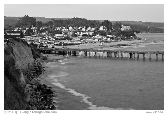 Cliff, Fishing Pier at sunset, and village. Capitola, California, USA