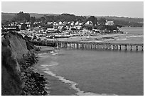 Cliff, Fishing Pier at sunset, and village. Capitola, California, USA (black and white)
