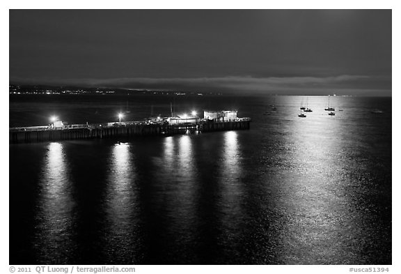 Pier and yachts with moon reflection. Capitola, California, USA